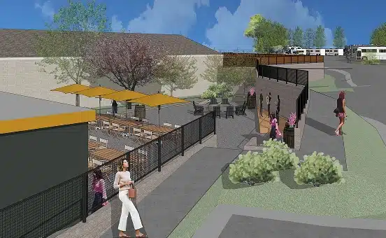 Person Walking by Outdoor Cafe