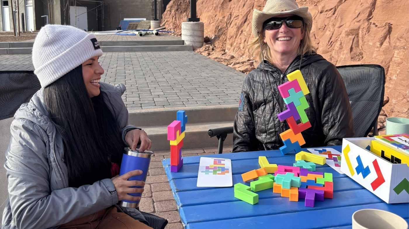 Families playing games outside their RV at a Flagstaff campground.